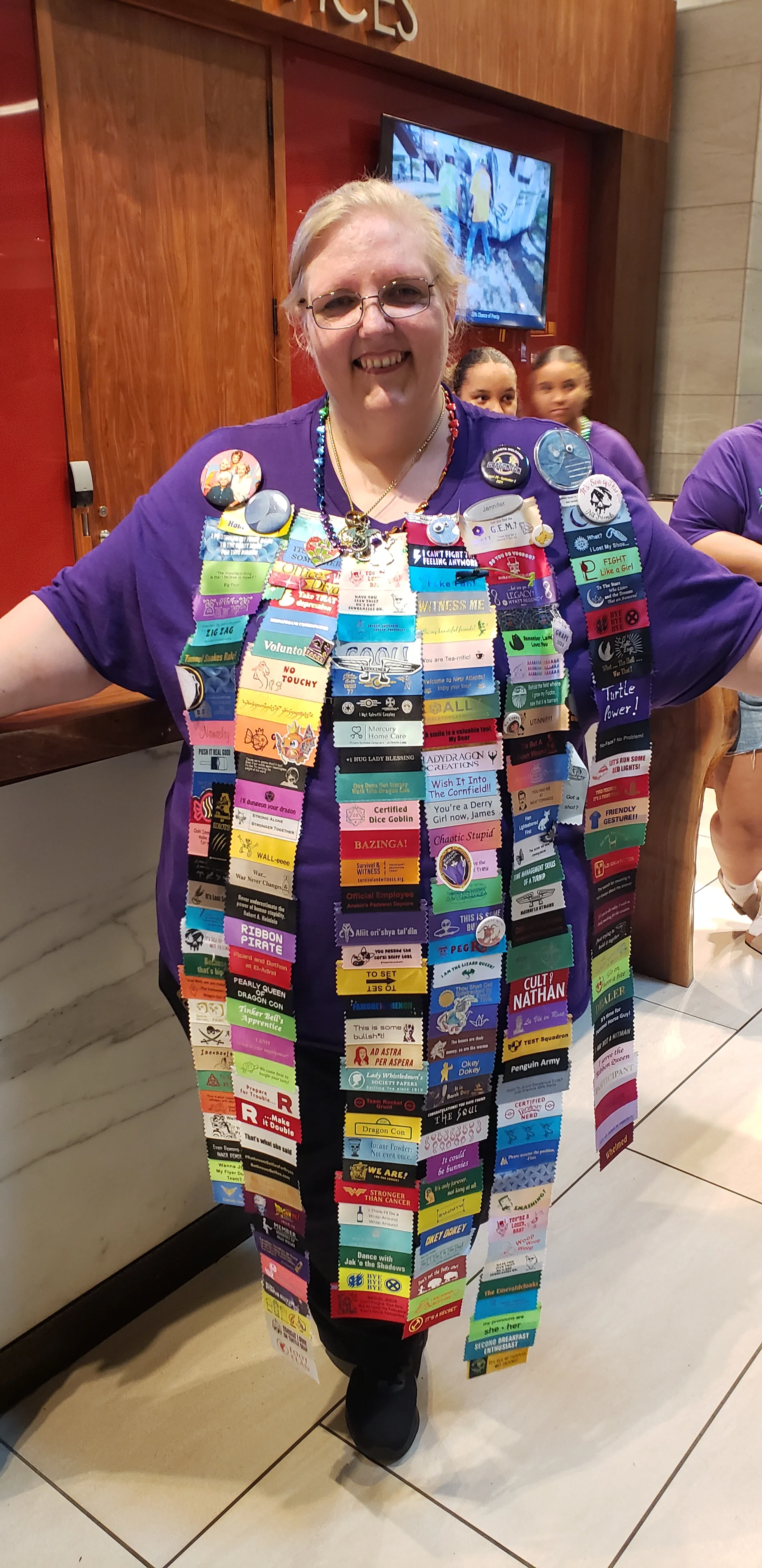 Epic Badge Ribbons on Hotel Employee at Dragon Con 2024